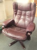 A late 20th century Burgundy leather swivel armchair