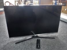 A Samsung 32 inch LCD TV with lead and remote
