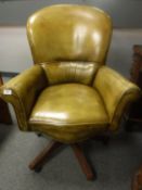 An olive green leather swivel office chair,