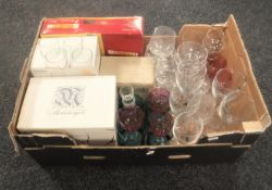 A box of boxed and unboxed glass ware