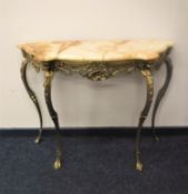 A shaped onyx-topped hall table on gilt metal base