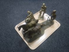 A cast brass figure of a ploughman and two similar miner figures