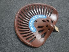 A cast metal tractor seat