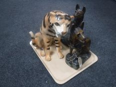 A pair of early 20th century pottery chalk Alsatian figures and a pottery tiger figure