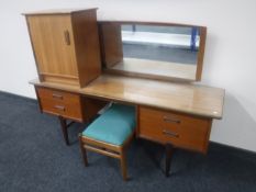 A mid 20th century teak kneehole dressing table fitted four drawers together with matching bedside