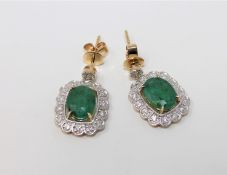 A pair of 14ct yellow gold emerald and diamond earrings featuring 2 cushion cut emeralds 3.