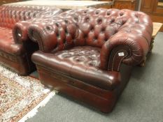 A red leather Chesterfield armchair,
