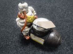 A cast metal figure of Michelin Man on compressor
