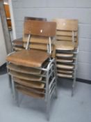 A set of eighteen mid 20th century tubular metal framed stacking school chairs