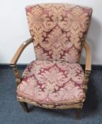 A mid 20th century bedroom chair upholstered in a red and gold classical buttoned fabric