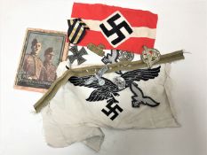 A collection of German Third Reich articles including Swastika arm band, Iron Cross,