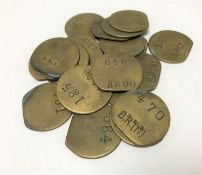 Twenty vintage brass railway pay check tokens.