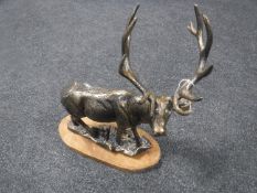 A cast metal figure of a stag on metal base