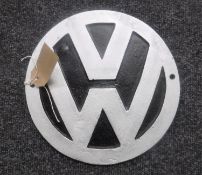 A cast metal plaque "VW"