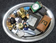 An oval tray of miniature Victorian photograph album, mantel clock, miniature brass coal helmet,