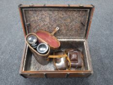 A miniature vintage travelling trunk containing leather cased military field glasses and two