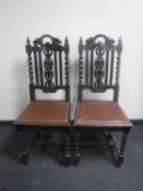 A pair of antique carved oak dining chairs