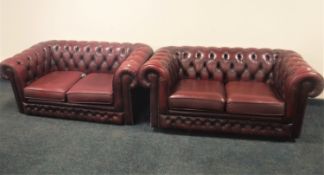A pair of red buttoned leather Henry Lloyd Chesterfield style settees