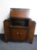 A 1930's oak bureau with shelves either side and a gate leg table