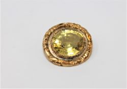 A Victorian citrine brooch in chased yellow metal setting