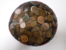 A tin containing pre-decimal copper coins,