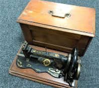 An early 20th century mahogany cased Singer hand sewing machine