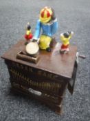 A cast metal organ grinder money box