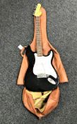 An Encore electric guitar in soft carry case