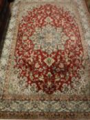 A Keshan carpet, on red ground,