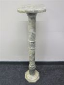 A marble plant pedestal