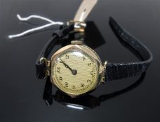 A vintage 9ct gold lady's watch on black leather strap