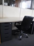 An Ikea desk with five drawer pedestal and swivel leather armchair