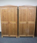 A pair of pine double door wardrobes