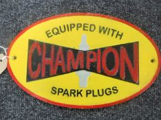 A cast metal plaque "Champion spark plugs"