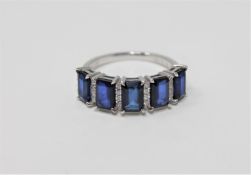 A 14ct white gold sapphire and diamond ring featuring 5 emerald cut natural sapphires 2.