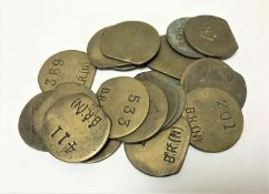 Twenty vintage brass railway pay check tokens.