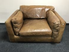 A brown leather over sized armchair