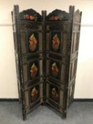 A painted and ebonised four-fold screen depicting panels of fruit