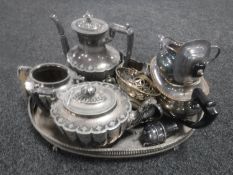 An antique plated gallery tray on paw feet together with a quantity of plated wares including