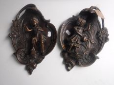 A pair of continental bronze wall plaques
