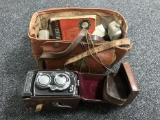 A Rolleiflex camera in leather case with original Rolleiflex guide,