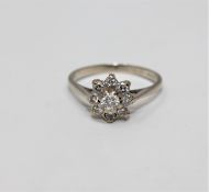 An 18ct gold diamond cluster ring, the principal stone weighing approximately 0.