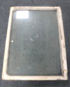 An antique etched glass window in frame CONDITION REPORT: 91cm by 65cm excluding