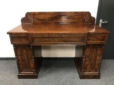 An early 19th century mahogany breakfronted pedestal sideboard,