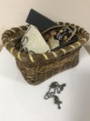 A basket of costume jewellery, silver cross on chain,