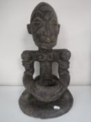 A carved tribal figure of an African fertility god