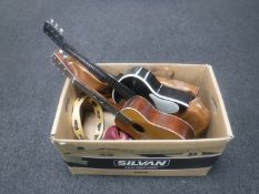 A box of Chinese Lark acoustic guitar and one other, tambourine, pair of leather boxing gloves,