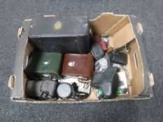 A box containing vintage cameras and accessories