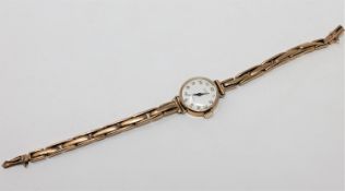 A lady's 9ct gold Summit wristwatch on yellow metal expanding strap CONDITION REPORT: