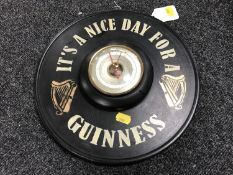 A circular Short & Mason barometer mounted on board bearing Guinness advertising